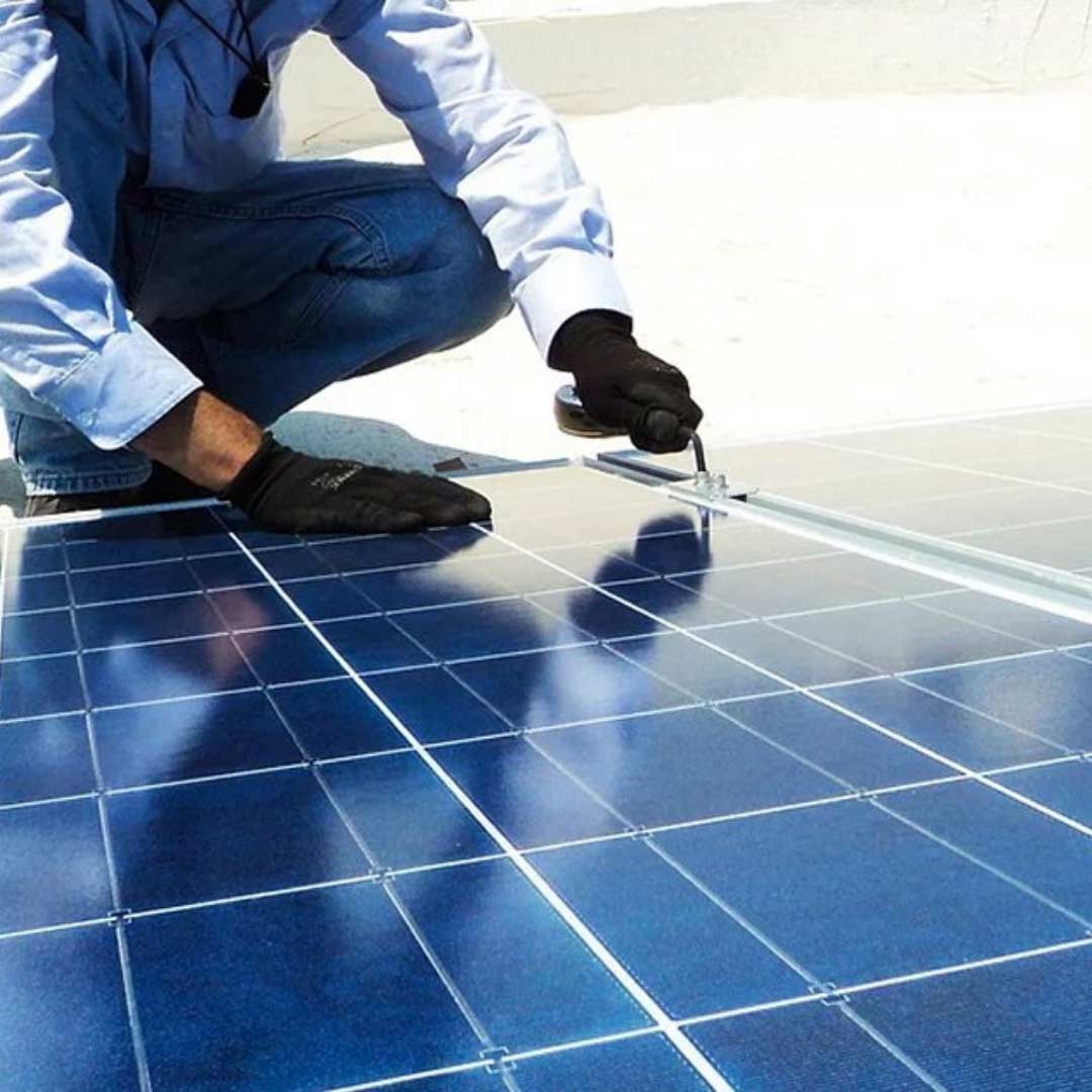 a man working to connect solar panel together